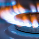 Flames natural gas kitchen stove. Red and blue flame close up